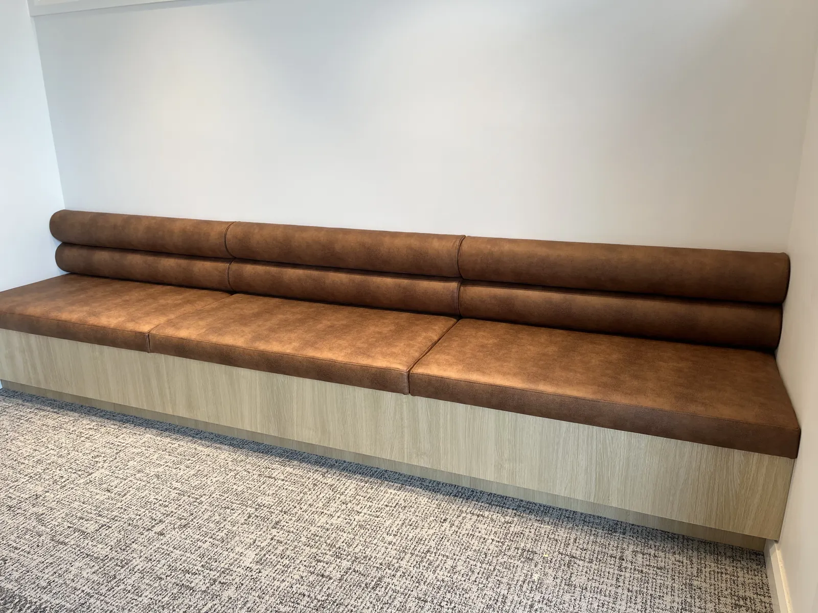 Tan banquette seating on timber bases at Dental House, Taylors Lakes